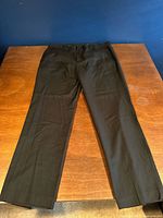 Full view of black dress pants laid flat