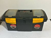 Closed black toolbox front view with stickers