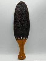 Full view of paddle front showing wood handle and beaver tail blade