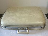 Closed suitcase top view showing exterior texture and handle