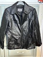 Front view of Wilsons Leather black jacket hanging