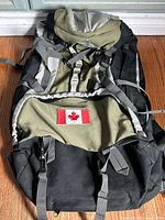 Front view of Woods backpack showing Canadian flag patch and strap layout