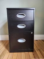 front view showing three drawers, integrated handles, lock on lower drawer