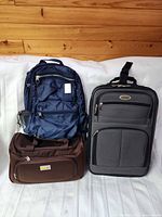 Group shot of backpack, suitcase and duffle