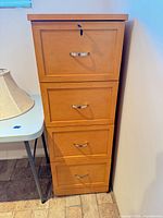 Front view of four-drawer wood filing cabinet