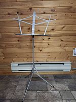 Full view of stand assembled upright showing tripod base and sheet holder