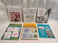 Front covers of all six instruction books arranged upright
