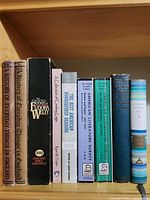 shelf containing assorted books unrelated to seller description
