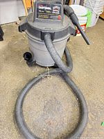 Front view of Craftsman wet/dry vacuum with hose attached