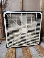 Front view showing grille, blades, and metal housing