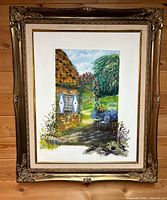 Front view of framed cottage garden painting showing artwork, signature, mat and ornate frame