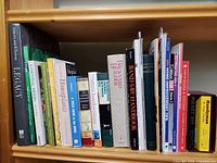 Shelf of assorted DIY, gardening and reference books, full view