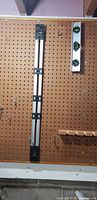 Johnson Mark-It level and 12 in. aluminum level on pegboard