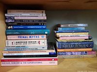 Two stacks of mythology books showing spines and titles