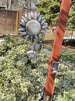 Full view of sunflower stake in garden setting
