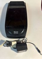 Top view of Recoton VHS cassette rewinder with power adapter