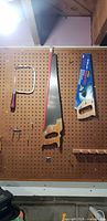 Hacksaw frame, Stanley hand saw with blade guard, small hand saw in package on pegboard