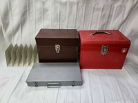 Front view of red, brown, gray toolboxes and beige divider