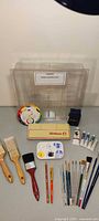 Entire lot layout including Pelikan tin, storage container, brushes, palette, tubes, color wheel