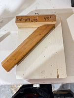 Top view of wooden 45° mitre jig on white base