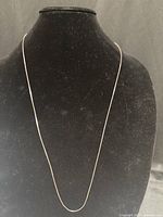 Full view of sterling silver chain on display bust