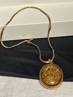 Full view of necklace laid flat showing chain and pendant