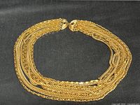 Full view of necklace laid in oval form showing multi-strand design