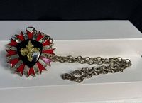 Full view of necklace with sunburst pendant and silver-tone chain