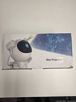 Retail box showing astronaut star projector branding