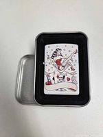 Lighter in open storage tin showing full front graphic