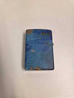 Front view of closed lighter showing distressed blue finish