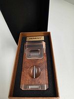 Lighter in foam-lined presentation box showing wood-grain finish and V-cutter