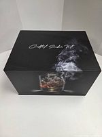 Closed black gift box labeled Cocktail Smoker Kit