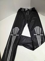 Full view of black leggings with printed knee armor and stripes