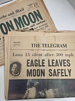 Stack showing The Telegram front page 'EAGLE LEAVES MOON SAFELY' with The Globe and Mail beneath