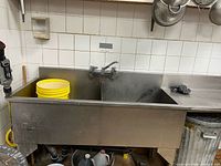 Full view of sink showing two basins, faucet and partial drainboard