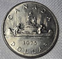Reverse showing Voyageur canoe design with date 1975 and CANADA DOLLAR legend