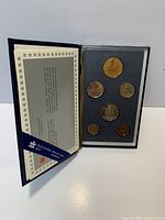 Open presentation case showing all six mounted coins and specification card