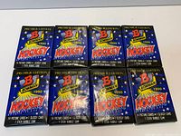 Eight sealed Bowman 1990 Hockey wax packs displayed