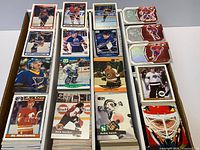 Open card box showing stacks of assorted hockey cards sorted upright by set
