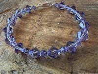 Full view of bracelet showing all faceted purple crystals and clasp