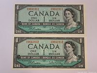 Obverse of both banknotes showing consecutive star serial numbers and Queen Elizabeth II portrait