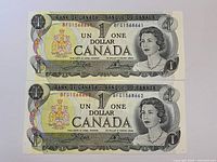 Obverse of both 1973 one-dollar notes showing Queen Elizabeth II portraits and consecutive serial numbers