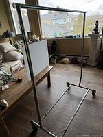 Garment rack assembled showing chrome frame and caster wheels