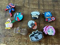 Front view of nine Crocs Jibbitz charms on tabletop