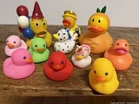 Front and top view of all 11 themed rubber ducks