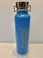 Full view of blue elumind insulated bottle standing upright