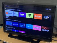 Full view of Emerson 32-inch TV powered on showing menu screen