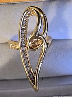 Front view of gold-tone fashion ring showing elongated design and stone setting