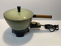 overall view of assembled green electric fondue pot with lid, handle, base and cord